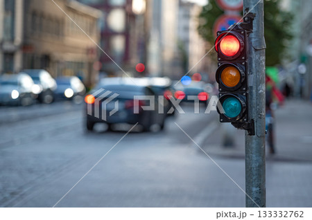 view of city traffic with traffic lights, in the foreground a traffic light with a red light 133332762