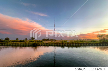 Tranquil twilight scene featuring reflective tower amidst natural Tranquil twilight scene featuring reflective tower amidst natural 133332894
