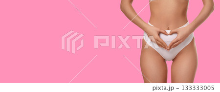 Hands on abdomen create a heart shape for body care 133333005