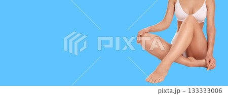 Woman practicing body care while seated on a clear background 133333006