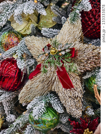 Festive Christmas decorations featuring a star-shaped ornament and colorful baubles in a winter scene Festive Christmas decorations featuring a star-shaped ornament and colorful baubles in a winter scene 133333878
