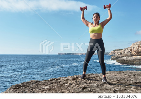 young woman doing yoga on the beach 133334076