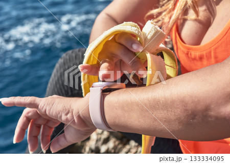 woman with a bottle of water on a beach 133334095