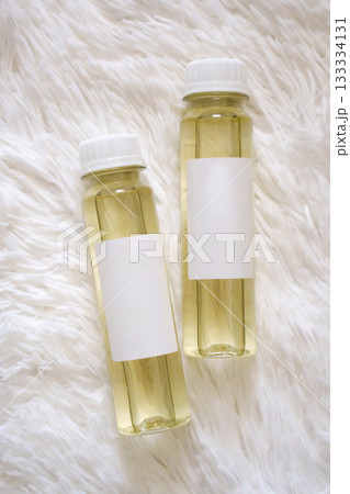 Essential oils for aroma diffuser placed on soft, fluffy surface 133334131