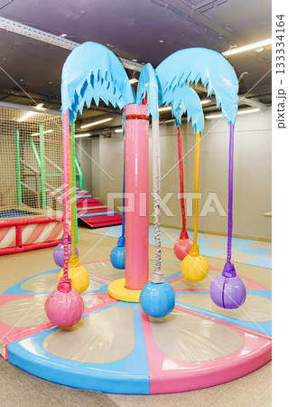 Colorful play area with soft swings and palm tree design Colorful play area with soft swings and palm tree design 133334164
