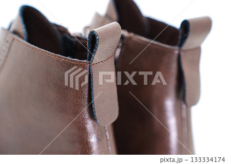 Stylish brown leather ankle boots with unique design 133334174