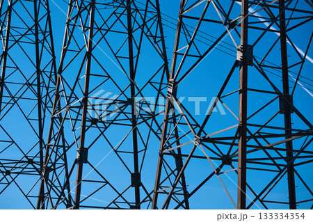 Metal towers reach high under a bright blue sky 133334354