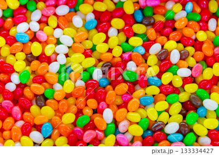 Colorful background of multicolored, shiny, round, chewy candies. A background photo of colorful sweets. A close-up photo of the candies taken in a candy store Colorful background of multicolored, shiny, round, chewy candies. A background photo of colorful sweets. A close-up photo of the candies taken in a candy store 133334427