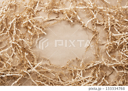 Kraft paper background With natural shredded packaging filler Frame, copy space 133334768