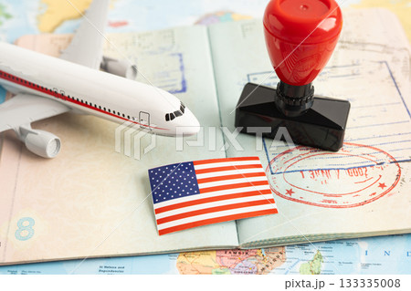 Approved Stamp visa and passport with US flag document to immigration at airport in country. Approved Stamp visa and passport with US flag document to immigration at airport in country. 133335008