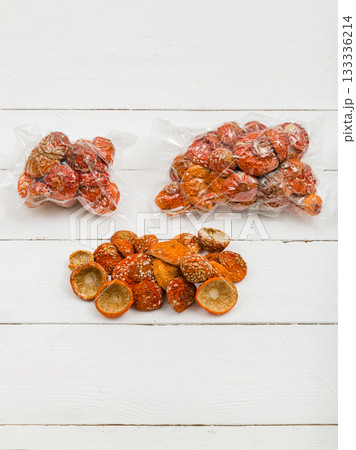 Dried fly agaric in a transparent package on a white background. Dried fly agaric in a transparent package on a white background. 133336214