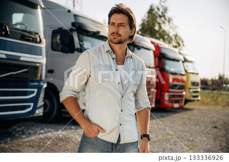 On the parking lot. Truck driver is near the transport outdoors On the parking lot. Truck driver is near the transport outdoors 133336926