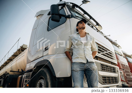 View from below, standing and posing. Truck driver is near the transport outdoors 133336936