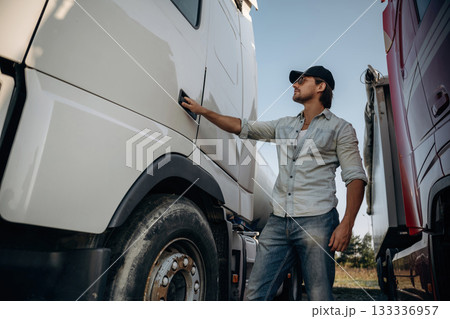 Opening the door. Truck driver is near the transport outdoors Opening the door. Truck driver is near the transport outdoors 133336957