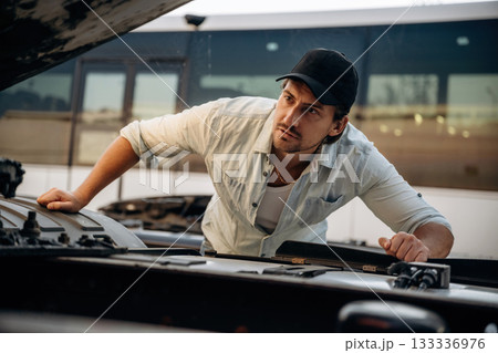 Truck driver is near the transport outdoors Truck driver is near the transport outdoors 133336976