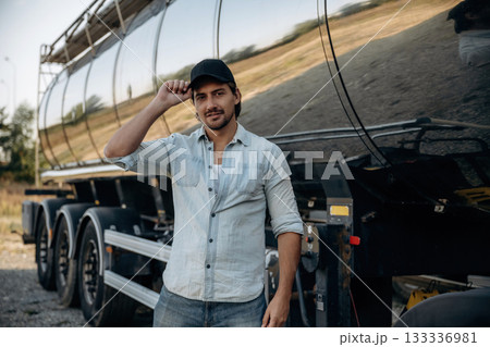 Fuel tank is behind. Truck driver is near the transport outdoors 133336981