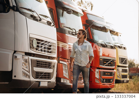 Truck driver is near the transport outdoors Truck driver is near the transport outdoors 133337004