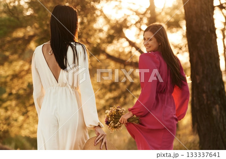 Rear view. Lovely lesbian couple are together outdoors in nature Rear view. Lovely lesbian couple are together outdoors in nature 133337641
