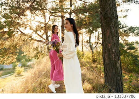 Having a walk. Lovely lesbian couple are together outdoors in nature 133337706