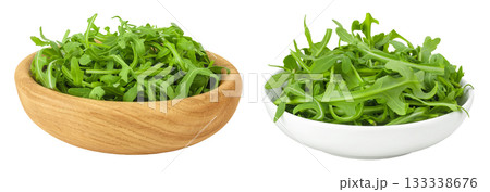 Heap of green fresh rucola or arugula leaf in wooden and ceramic bowl isolated on white background 133338676