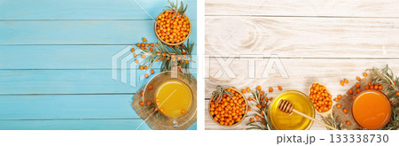 Sea buckthorn juice or tea with berries on a blue and white wooden background with copy space for your text. Top view 133338730
