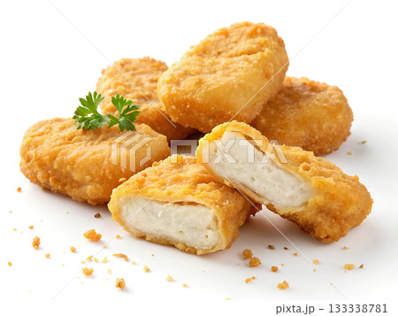 Pile of golden chicken nuggets on a white background one broken open Food 133338781