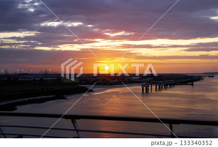 Stunning Sunrise Over Calm Waters in the Port of Tilbury England Stunning Sunrise Over Calm Waters in the Port of Tilbury England 133340352
