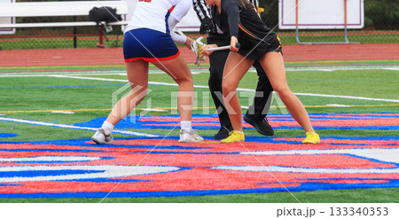 Two Players Compete for the Ball During a Lacrosse Faceoff Two Players Compete for the Ball During a Lacrosse Faceoff 133340353