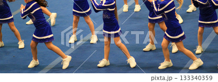 Youth Cheerleaders Perform on Blue Gym Floor at Competition 133340359