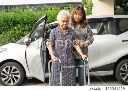 Caregiver help Asian elderly woman disability patient get in her car. Caregiver help Asian elderly woman disability patient get in her car. 133341409
