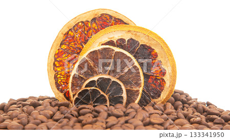 Detailed shot of dried citrus slices with vibrant hues, surrounded by aromatic coffee  133341950