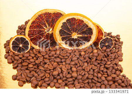 An enticing macro shot of dried citrus slices paired with dark coffee beans, 133341971