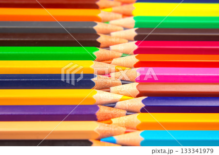 Colorful pencils in a stacked grid pattern against a white surface Colorful pencils in a stacked grid pattern against a white surface 133341979
