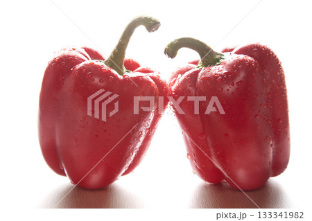 two red peppers in the water droplets on white background. 133341982