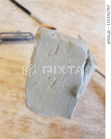 Sculpting Moment: Grey Clay and Artisan's Hand 133342767