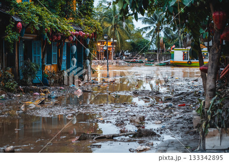 flooded city or town with buildings submerged in overflow water and mud, village underwater after heavy tropical rain and typhoon, consequences with dirt on the street 133342895