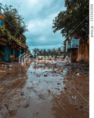 flooded city or town with buildings submerged in overflow water and mud, village underwater after heavy tropical rain and typhoon, consequences with dirt on the street flooded city or town with buildings submerged in overflow water and mud, village underwater after heavy tropical rain and typhoon, consequences with dirt on the street 133342898