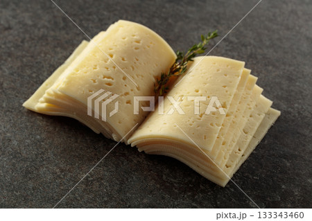 Cheese slices folded like an open book. 133343460