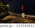 Rainy season storm damage on Nha Trang beach with “No Swimming” warning sign 133343622