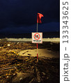 Rainy season storm damage on Nha Trang beach with No Swimming warning sign 133343625