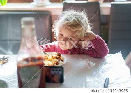 little girl eating salad at home 133343928