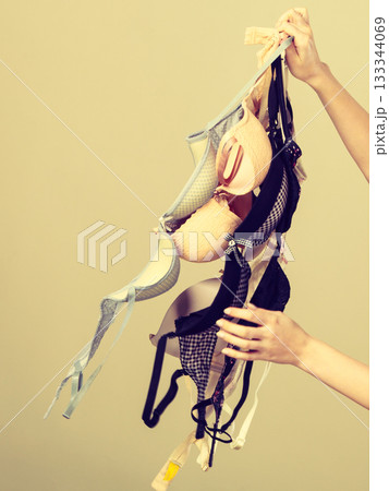 Female hand with many bras to wear Female hand with many bras to wear 133344069