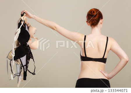 woman choosing bras to wear woman choosing bras to wear 133344071