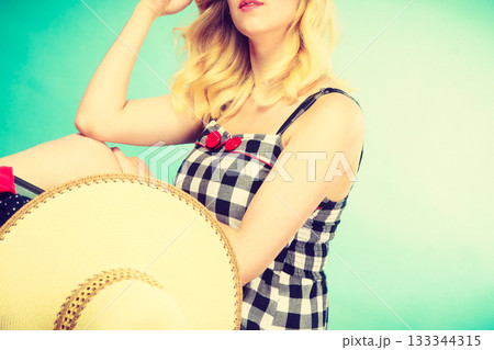 Portrait of attractive blonde woman in checked dress Portrait of attractive blonde woman in checked dress 133344315