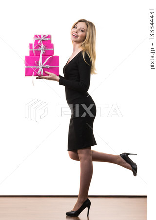 Girl holding stack of pink gift boxes 133344431