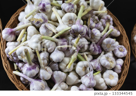 Fresh Garlic Bulbs in Wicker Basket at Market Fresh Garlic Bulbs in Wicker Basket at Market 133344545