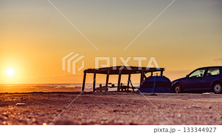 Tent on beach in sunrise light. 133344927