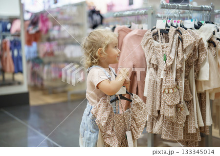 portrait of a little girl shopping in clothes store portrait of a little girl shopping in clothes store 133345014