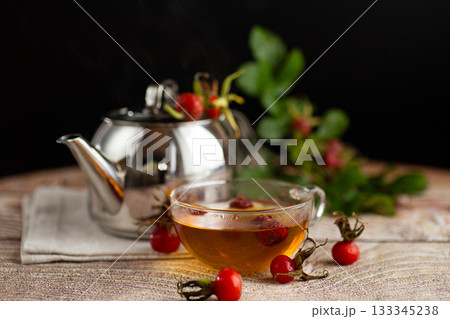 hot medicinal tea with rose hips in a cup on the table hot medicinal tea with rose hips in a cup on the table 133345238