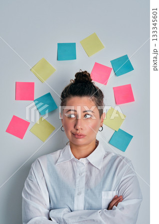 Woman brainstorming business ideas with sticky notes 133345601